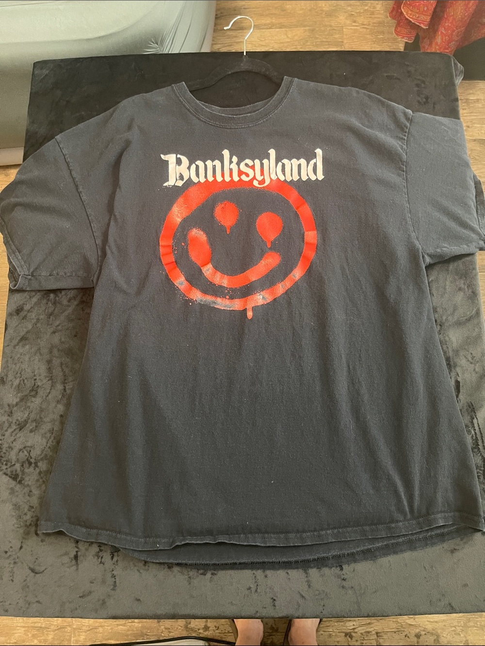 Banksyland Black Tee with Red Smiley Graphic